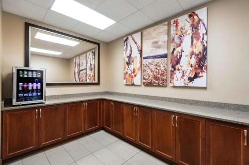 a waiting room with a counter and a tv at Embassy Suites by Hilton Saint Louis Saint Charles in St. Charles