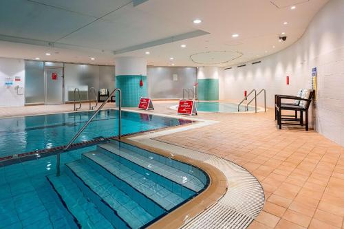 a large swimming pool in a building at Hilton Sydney in Sydney