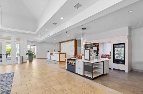 a large kitchen with a counter in a store at Hilton Garden Inn Auburn in Auburn
