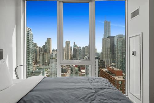 a bedroom with a large window with a view of a city at Level Chicago River North in Chicago