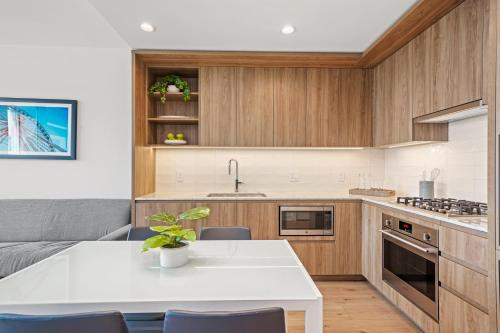 a kitchen with wooden cabinets and a white table at Level Chicago River North in Chicago