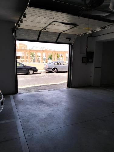 an empty garage with cars parked in a parking lot at Vivienda Turística Playa El Portil in El Portil