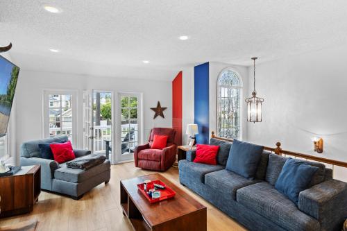 a living room with two couches and a table at The Americana 4 bedroom with spa and bikes, seps to the beach in Huntington Beach