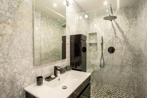 a bathroom with a sink and a shower at Deauville : magnifique studio en face du Casino ! in Deauville