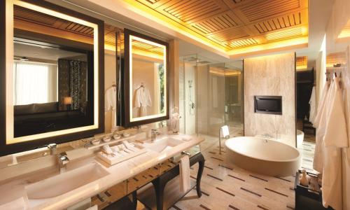 a bathroom with two sinks and a bath tub at Conrad Koh Samui Residences in Taling Ngam Beach