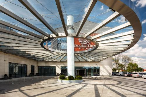 a building with a sign on the front of it at DoubleTree by Hilton Hotel & Conference Centre Warsaw in Warsaw