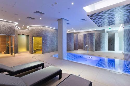 a large swimming pool in a building at DoubleTree by Hilton Hotel & Conference Centre Warsaw in Warsaw