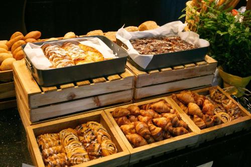 a display of different types of pastries in wooden boxes at DoubleTree by Hilton Hotel & Conference Centre Warsaw in Warsaw