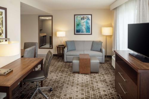 a living room with a couch and a television at Homewood Suites by Hilton Wallingford-Meriden in Wallingford