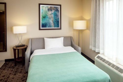 a hotel room with a bed and two lamps at Homewood Suites by Hilton Wallingford-Meriden in Wallingford