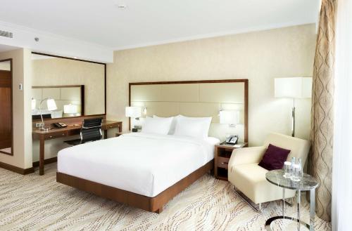 a hotel room with a bed and a desk and a chair at DoubleTree by Hilton Hotel & Conference Centre Warsaw in Warsaw