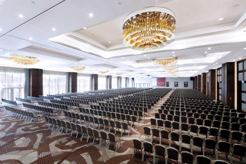 an empty hall with chairs and a chandelier at DoubleTree by Hilton Hotel & Conference Centre Warsaw in Warsaw