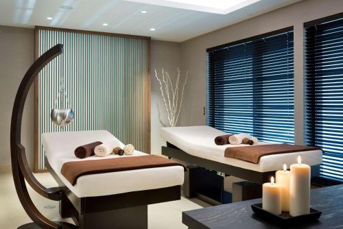 a hospital room with two beds and two candles at DoubleTree by Hilton Hotel & Conference Centre Warsaw in Warsaw
