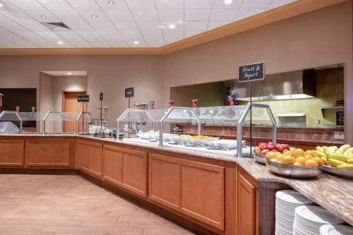 a buffet line in a restaurant with fruits and vegetables at Embassy Suites Northwest Arkansas - Hotel, Spa & Convention Center in Rogers