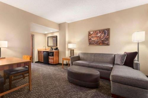 a living room with a couch and a table at Embassy Suites Northwest Arkansas - Hotel, Spa & Convention Center in Rogers
