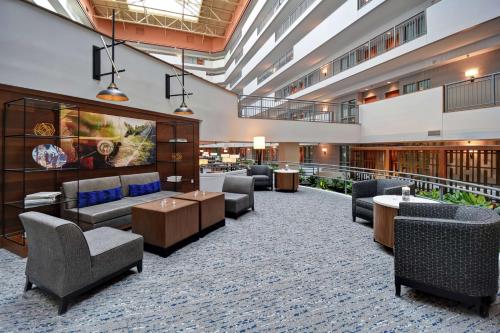 a hotel lobby with couches and chairs and tables at Embassy Suites by Hilton Omaha Downtown Old Market in Omaha