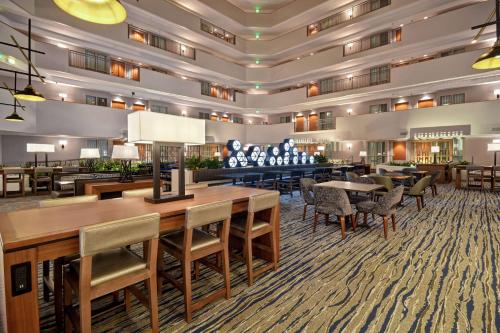 a large hotel lobby with tables and chairs at Embassy Suites by Hilton Omaha Downtown Old Market in Omaha