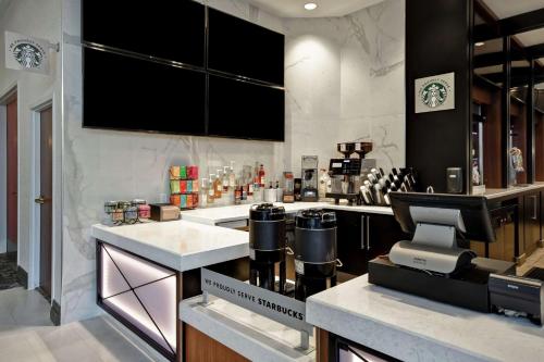 a kitchen with a counter with a coffee machine at Embassy Suites by Hilton Omaha Downtown Old Market in Omaha