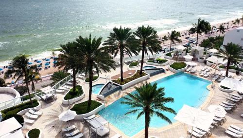 an aerial view of a resort with a swimming pool and the beach at Hilton Fort Lauderdale Beach Resort in Fort Lauderdale