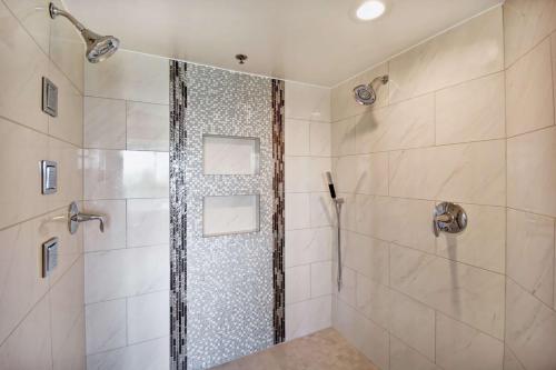 a shower with a glass door in a bathroom at Embassy Suites by Hilton Omaha Downtown Old Market in Omaha