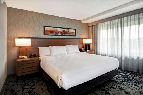 a hotel room with a large bed and a window at Embassy Suites by Hilton Omaha Downtown Old Market in Omaha