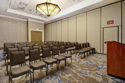 a room with rows of chairs and a podium at Embassy Suites by Hilton Omaha Downtown Old Market in Omaha