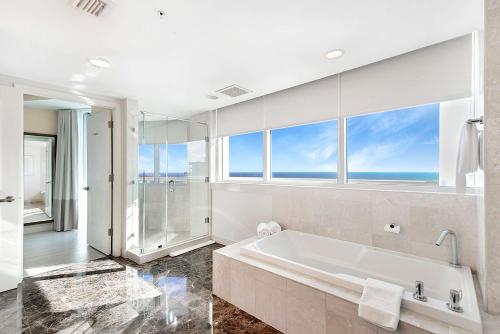 a bathroom with a large tub and a large window at Hilton Fort Lauderdale Beach Resort in Fort Lauderdale