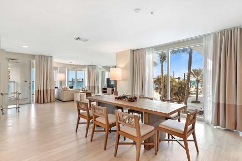 a dining room with a table and chairs and a living room at Hilton Fort Lauderdale Beach Resort in Fort Lauderdale