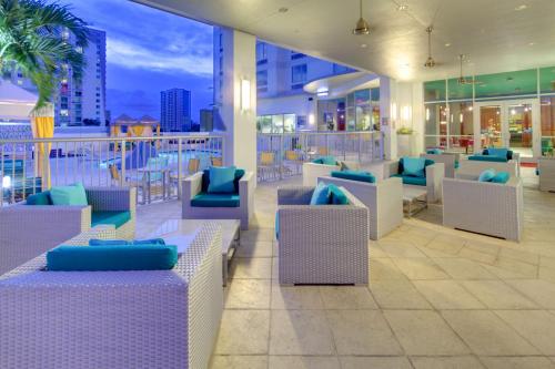 a restaurant with blue and white chairs and a balcony at Hampton Inn & Suites by Hilton Miami Downtown/Brickell in Miami