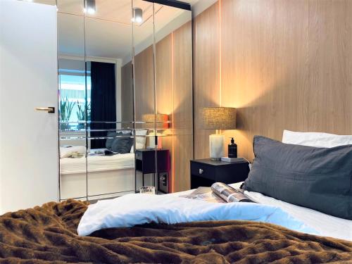 ein Schlafzimmer mit einem Bett und einem großen Spiegel in der Unterkunft LUXURY Apartment at City CENTER at Palace +Netflix! in Warschau