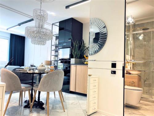 a kitchen and dining room with a table and chairs at LUXURY Apartment at City CENTER at Palace +Netflix! in Warsaw