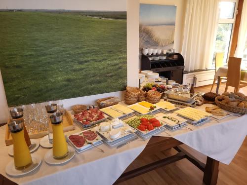 a table with a buffet of food on it at Naturhotel Baltrum in Baltrum