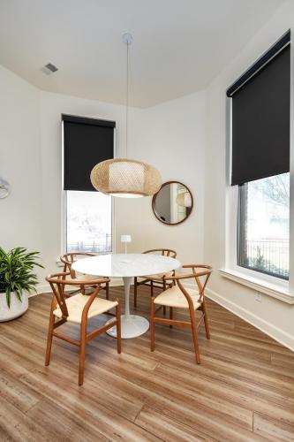 a dining room with a table and chairs and a mirror at The Lumber Baron's Mansion: 2 King Suites, 2.5BA + Gym in Detroit