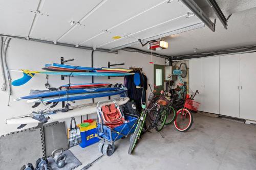 a garage with several bikes parked in it at The Americana 4 bedroom with spa and bikes, seps to the beach in Huntington Beach