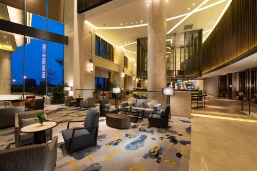 a lobby of a hotel with couches and chairs at Hilton Zhoushan in Zhoushan