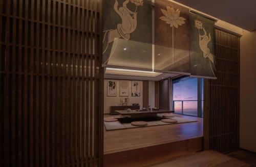 a bathroom with a sink and a large window at Hilton Zhoushan in Zhoushan