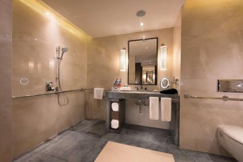 a bathroom with a sink and a mirror at Hilton Zhoushan in Zhoushan