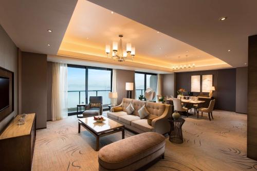 a living room with a couch and a table at Hilton Zhoushan in Zhoushan