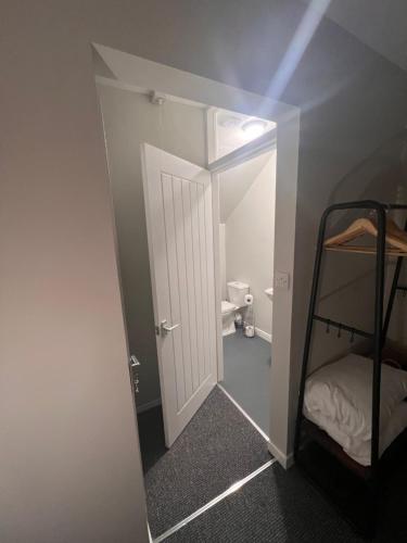 a small room with a door and a bunk bed at La Fattoria in Durham