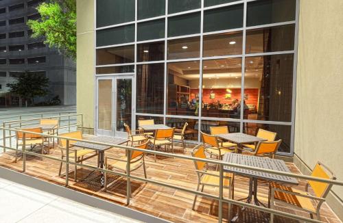 a balcony with tables and chairs on a building at Hampton Inn Houston Downtown in Houston