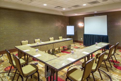 a conference room with tables and chairs and a screen at Hampton Inn Houston Downtown in Houston