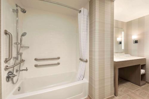 a bathroom with a bath tub and a sink at Homewood Suites by Hilton Chicago Downtown West Loop in Chicago