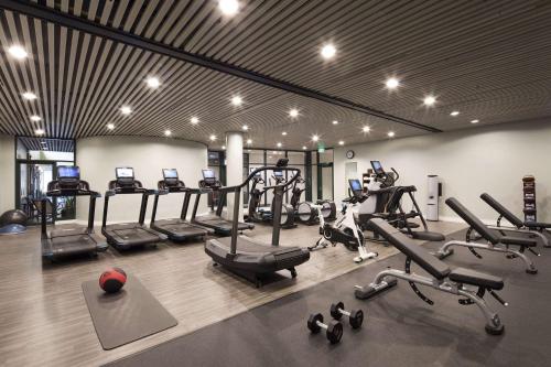 a gym with several treadmills and cardio machines at The Inverness Denver, a Hilton Golf & Spa Resort in Englewood