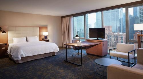 a hotel room with a bed and a television at Hampton Inn by Hilton Chicago Downtown West Loop in Chicago