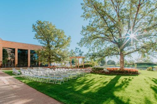 a group of chairs in front of a building at The Inverness Denver, a Hilton Golf & Spa Resort in Englewood