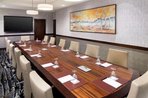 a large conference room with a long table and chairs at The Inverness Denver, a Hilton Golf & Spa Resort in Englewood