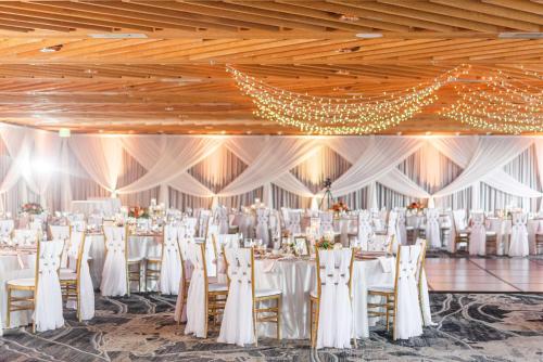 a wedding banquet hall with white tables and chairs at The Inverness Denver, a Hilton Golf & Spa Resort in Englewood