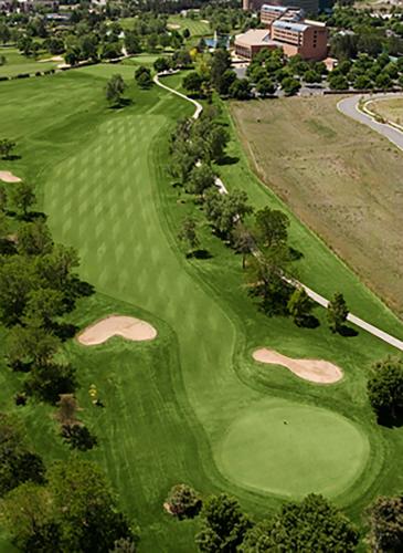 an overhead view of a green golf course at The Inverness Denver, a Hilton Golf & Spa Resort in Englewood