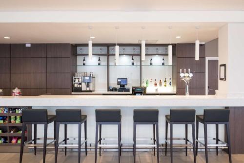 a kitchen with a bar with stools at Hampton By Hilton Aberdeen Airport in Dyce
