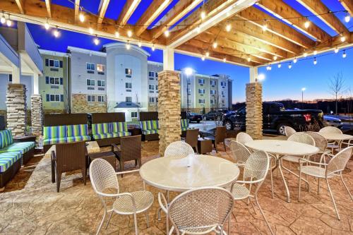 a patio with tables and chairs and a parking lot at Home2 Suites By Hilton Smyrna Nashville in Smyrna